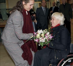 Doña Elena recibe un ramo de flores de manos de la tiradora paralimpica Gema Hassen-Bey