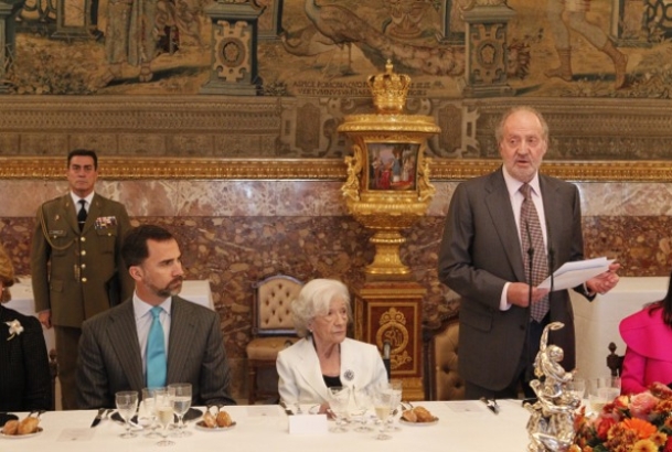 Don Juan Carlos, durante su discurso, junto a Ana María Matute y Don Felipe