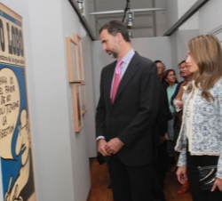 Don Felipe y Doña Letizia observan una viñeta humorística durante el recorrido por la Exposición