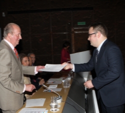 Don Juan Carlos entrega el diploma a uno de los jóvenes becados