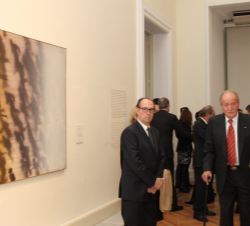 Su Majestad el Rey Don Juan Carlos, con la comisaria de la exposición y el pintor Rafael Canogar, junto a una obra de Juan Genovés