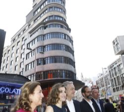 La Reina, a su llegada, con las personalidades que la recibieron, delante del Edificio Capitol de la Gran Vía madrileña.