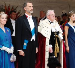 Sus Majestades los Reyes acompañados por el alcalde de la City de Londres y su esposa durante la interpretación del Himno Nacional a su llegada a Guil
