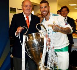 Don Juan Carlos sostiene la copa junto al capitán del Real Madrid, Sergio Ramos