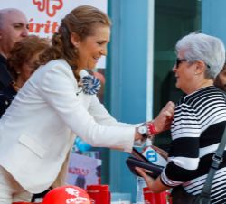 Su Alteza Real la Infanta Doña Elena impone el distintivo de Cáritas a una donante