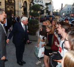 Su Majestad el Rey y el Presidente de Alemania a su llegada al acto conversan con un grupo de jóvenes que les esperanban a su llegada