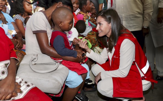 Su Majestad la Reina saluda cariñosamente a uno de los niños durante su visita al Centro de Salud de Manhiça