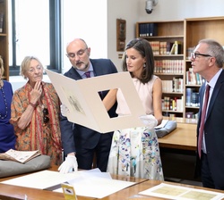 Su Majestad la Reina durante la visita examina una de las obras