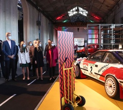 Los Reyes y sus hijas, la Princesa de Asturias y la Infanta Doña Sofía durante el recorrido por el “Taller Carlos Sainz” frente a uno de l