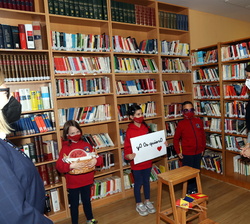 Sus Majestades los Reyes con alumnos de primaria en la biblioteca del Colegio Español María Moline