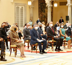 Sus Majestades los Reyes ocupan su lugar en primera fila de asientos junto a las autoridades