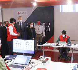 Don Felipe y Doña Letizia reciben las explicaciones del director de Inclusión Social en zona de trabajo de los voluntarios de Cruz Roja Española