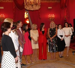 Su Majestad la Reina junto a los acompañantes de los participantes en la Cumbre de la OTAN durante la explicación por parte del presidente de la Funda