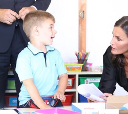 Uno de los alumnos explica su trabajo a Su Majestad la Reina