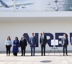 Don Felipe, acompañado de las autoridades, junto a la placa conmemorativa de su visita con ocasión del centenario de la creación de Construcciones Aer