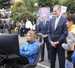 Su Majestad el Rey atiende a las explicaciones de Adrián Fernández, profesor y los alumnos Hugo Aguiar y Paula Rubio, del proyecto “simulador di