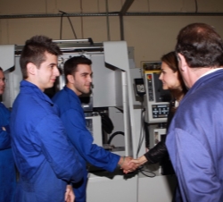 La Princesa de Asturias recibe el saludo de unos alumnos a su paso por el aula taller de máquinas especiales