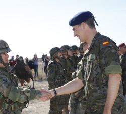 Don Felipe recibe el saludo de una militar participante en el ejercicio que porta un ave rapaz adiestrada