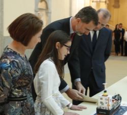 Su Majestad el Rey observa el trabajo de la niña ganadora, Marta Benítez Mora, por la Ciudad Autónoma de Ceuta