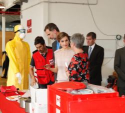Sus Majestades los Reyes durante su recorrido por las instalaciones a su paso por el almacen de Cruz Roja