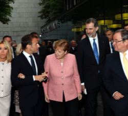 Don Felipe, acompañado por Emmanuel Macron y Ángela Merkel, a la finalización de la misa