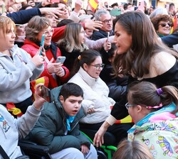 S.M. la Reina junto a un grupo de niños que estaba entre el público 
