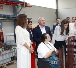 Sus Majestades los Reyes conversan con una de las rederas en el Puerto de Burela