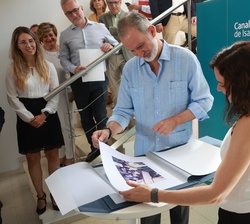 Don Felipe y la presidenta de la Comunidad de Madrid repasan las fotografías de la visita realizada en 1979